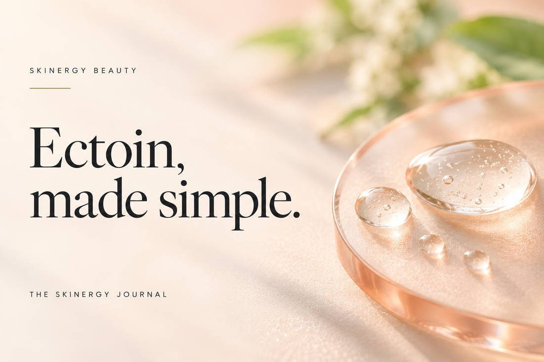 Illustrative clear serum droplets on peach glass beside Ectoin, made simple, on a Skinergy Journal cover.