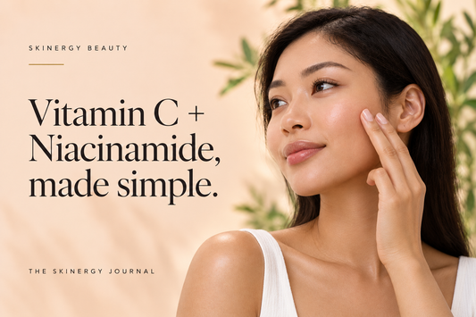 Woman gently patting serum onto her cheek beside Vitamin C + Niacinamide, made simple, on a peach Skinergy Journal cover.